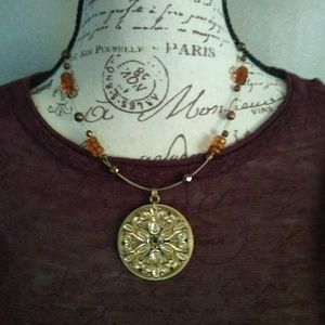Women's gold tone medallion necklace